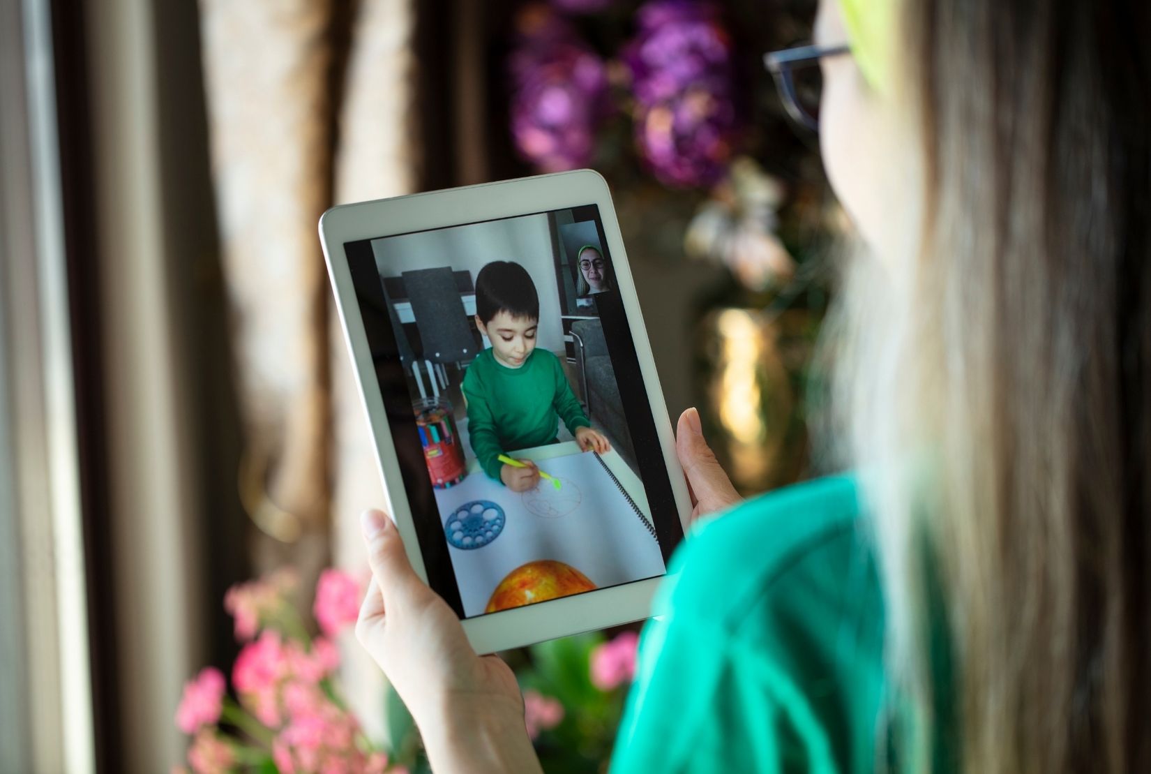 woman watching video of child