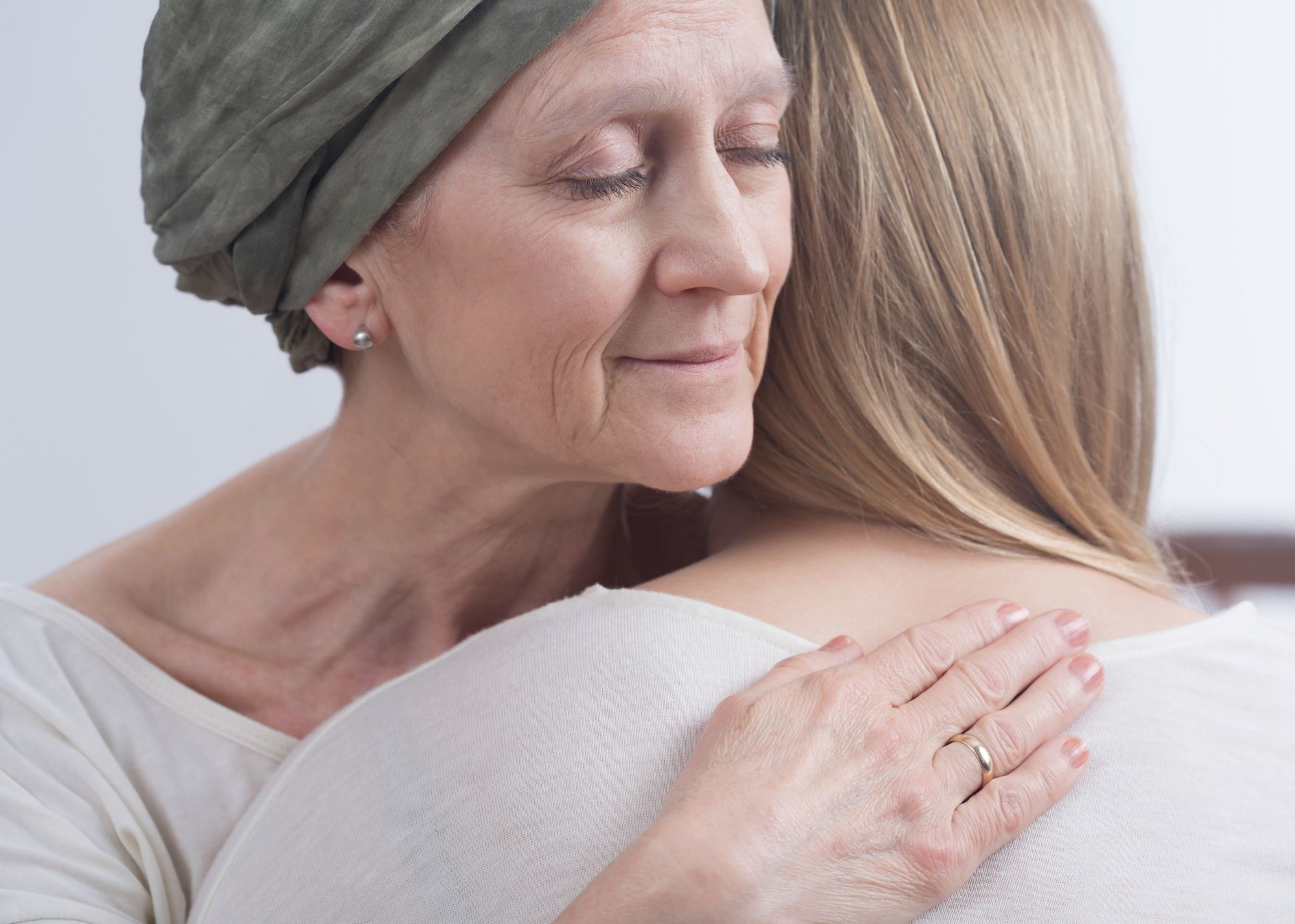 young woman hugging ill older woman