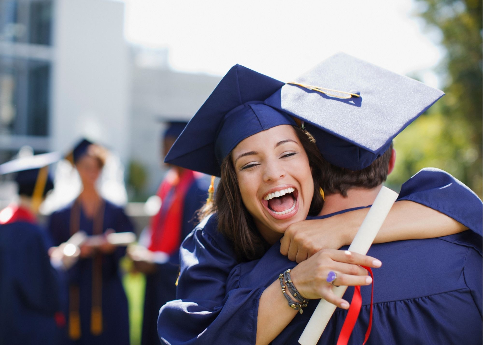 graduates hugging