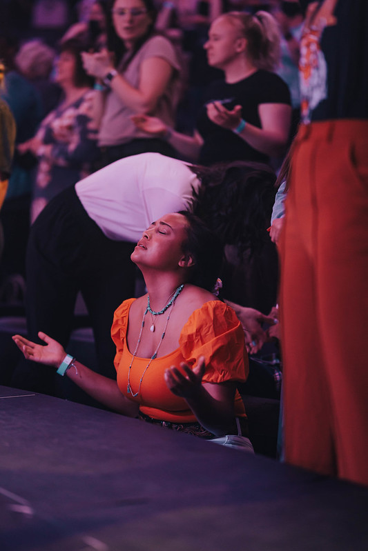 woman worshipping jesus at altar at church in omaha nebraska
