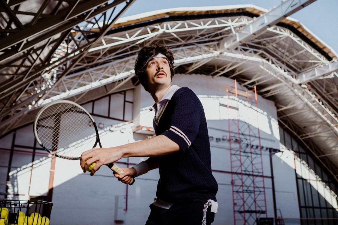 Free Man in Black Polo Shirt Holding Tennis Racket Stock Photo