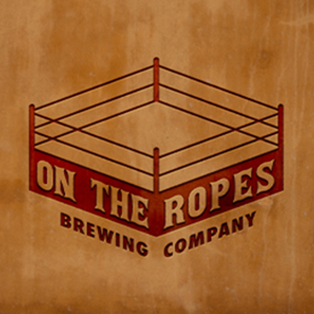 A logo for a brewing company. There is a drawing in red of a boxing ring and underneath the name "On the Ropes Brewing Company." The logo is placed on a distrssed brown background.