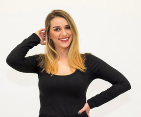 Picture of Abigael, smiling at the camera wearing a black long sleeve shirt