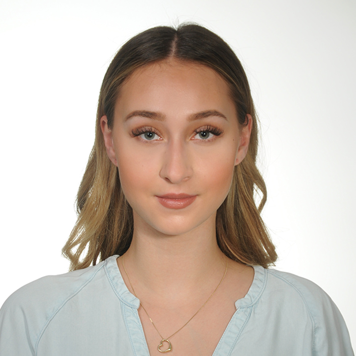 Portrait picture of Kinga, wearing a white blouse
