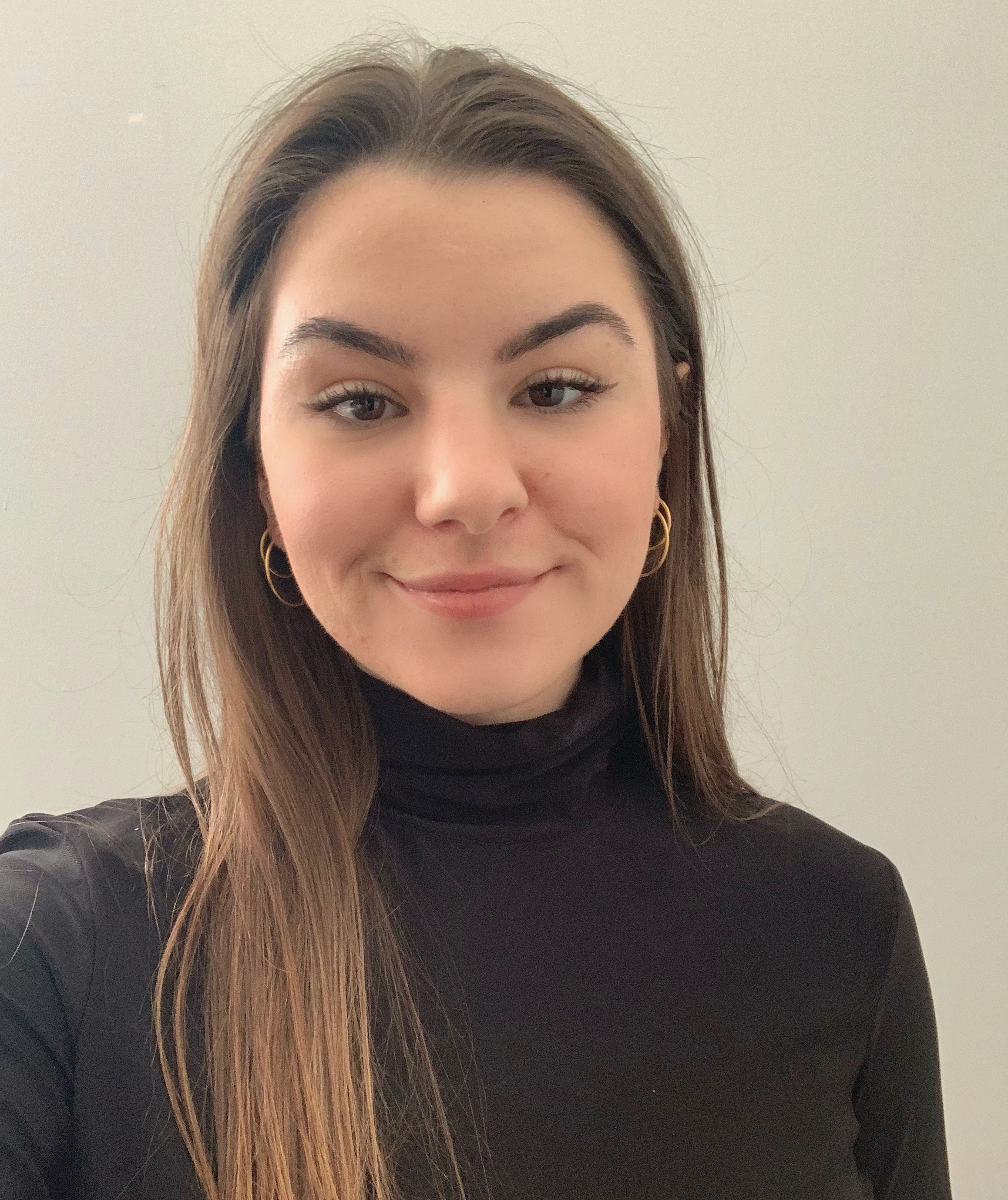 Picture of Mikayla, wearing a black turtle neck sweater