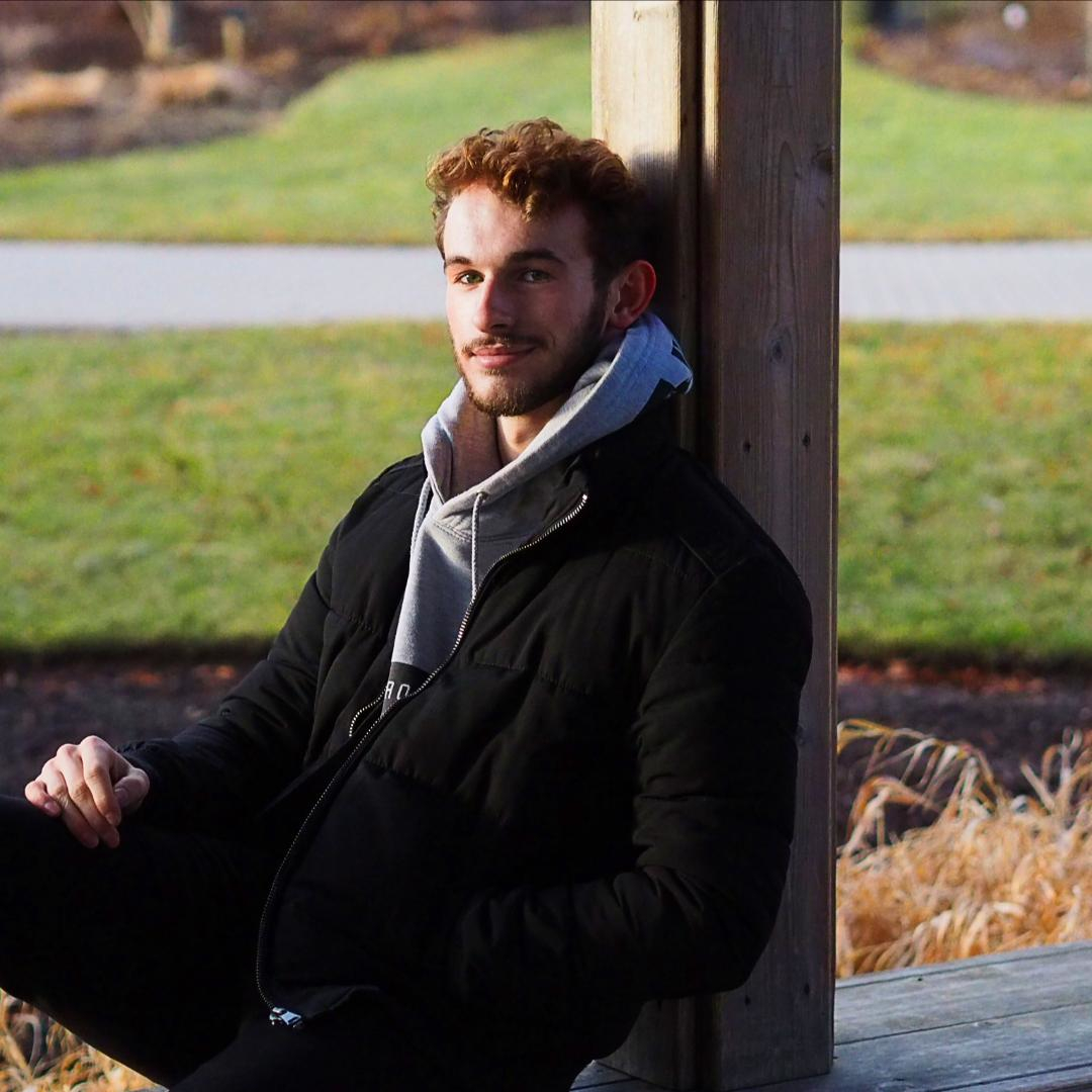 Image of Matt sitting in the park