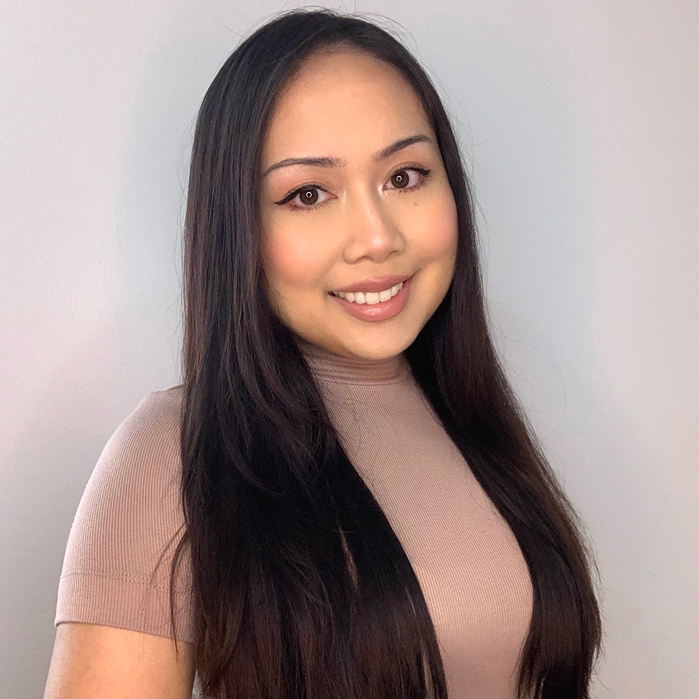 Picture of Allyson, looking to the camera wearing a brown nude colour shirt