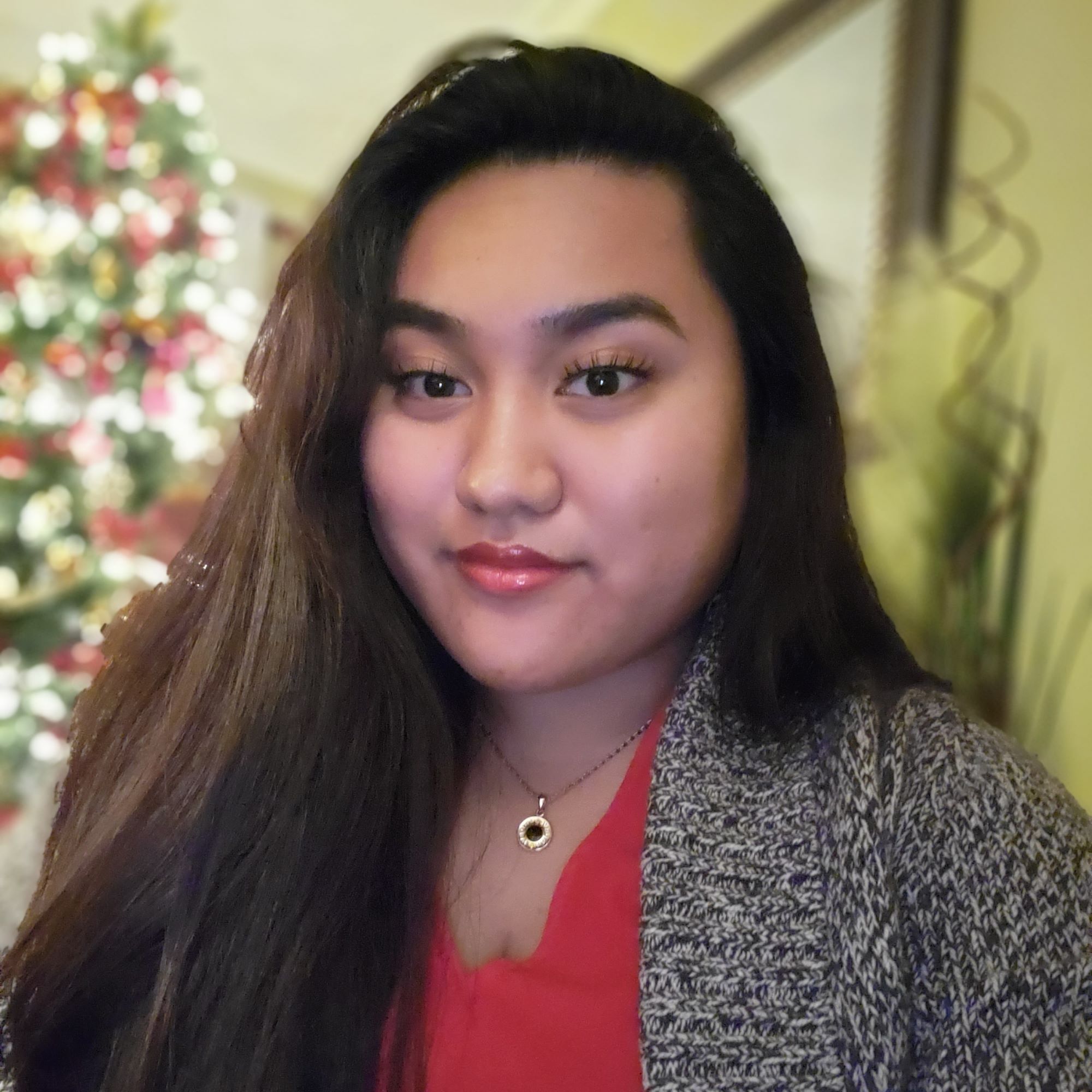Picture of Antonette, wearing a red blouse and grey sweater