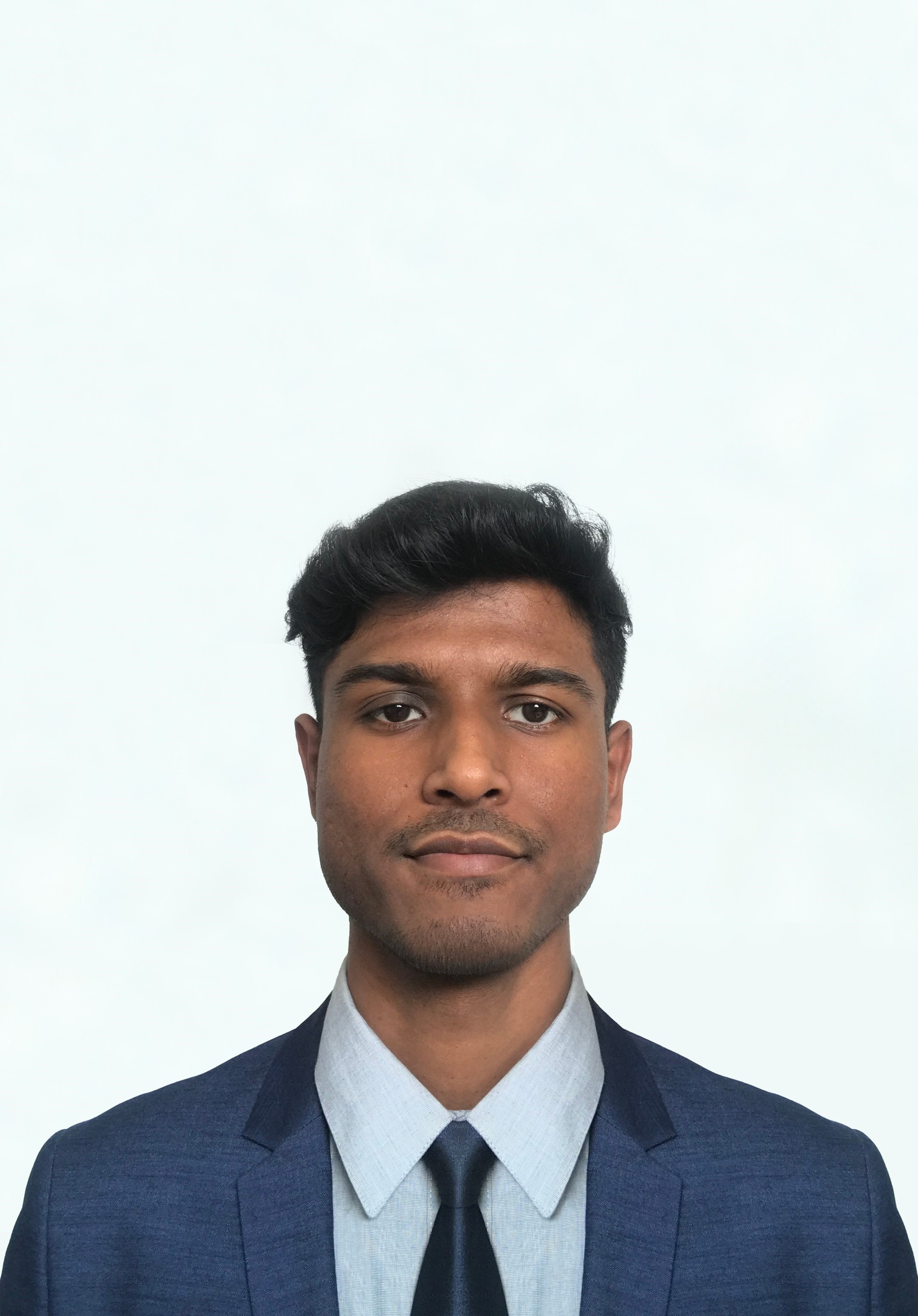 Picture of Dhruv Shah posing wearing a suit and tie