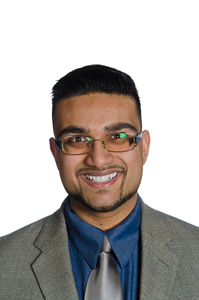 Picture of Faris, wearing a grey suit with a blue shirt