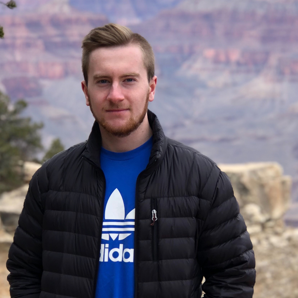 Picture of Jason Wootten wearing a blue t-shirt and a black jacket