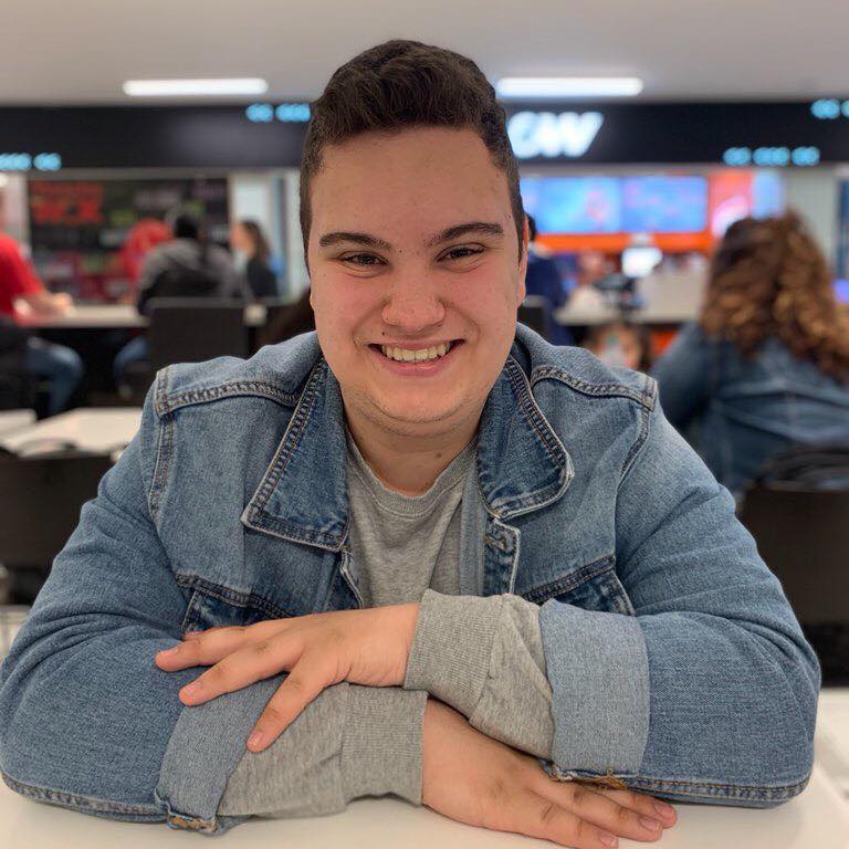 Picture of Nicolas, wearing a blue jean jacket and grey sweater