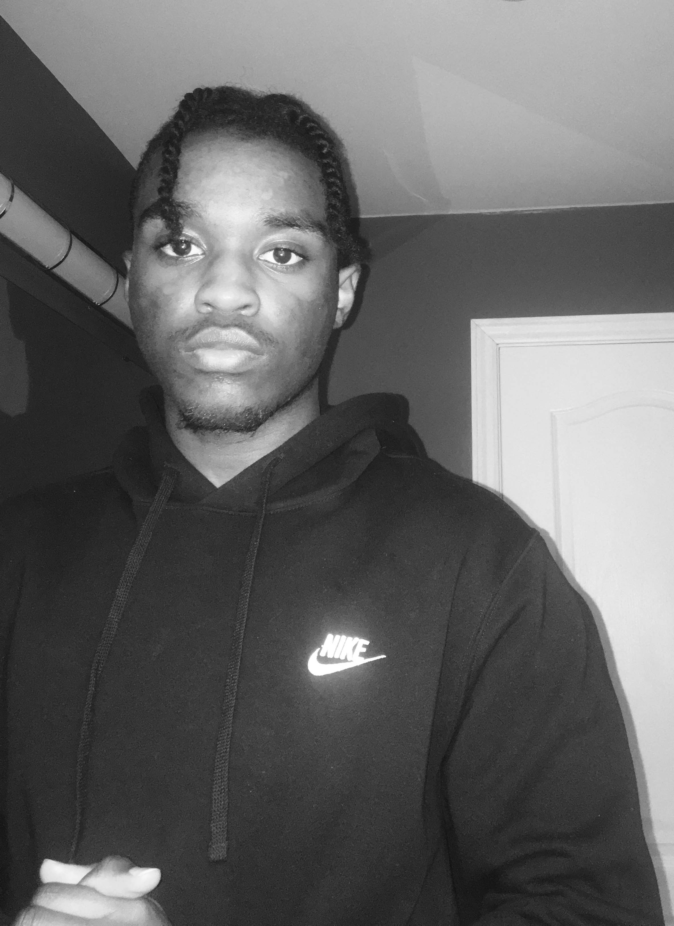Black and white picture of Quincy, wearing a hoodie
