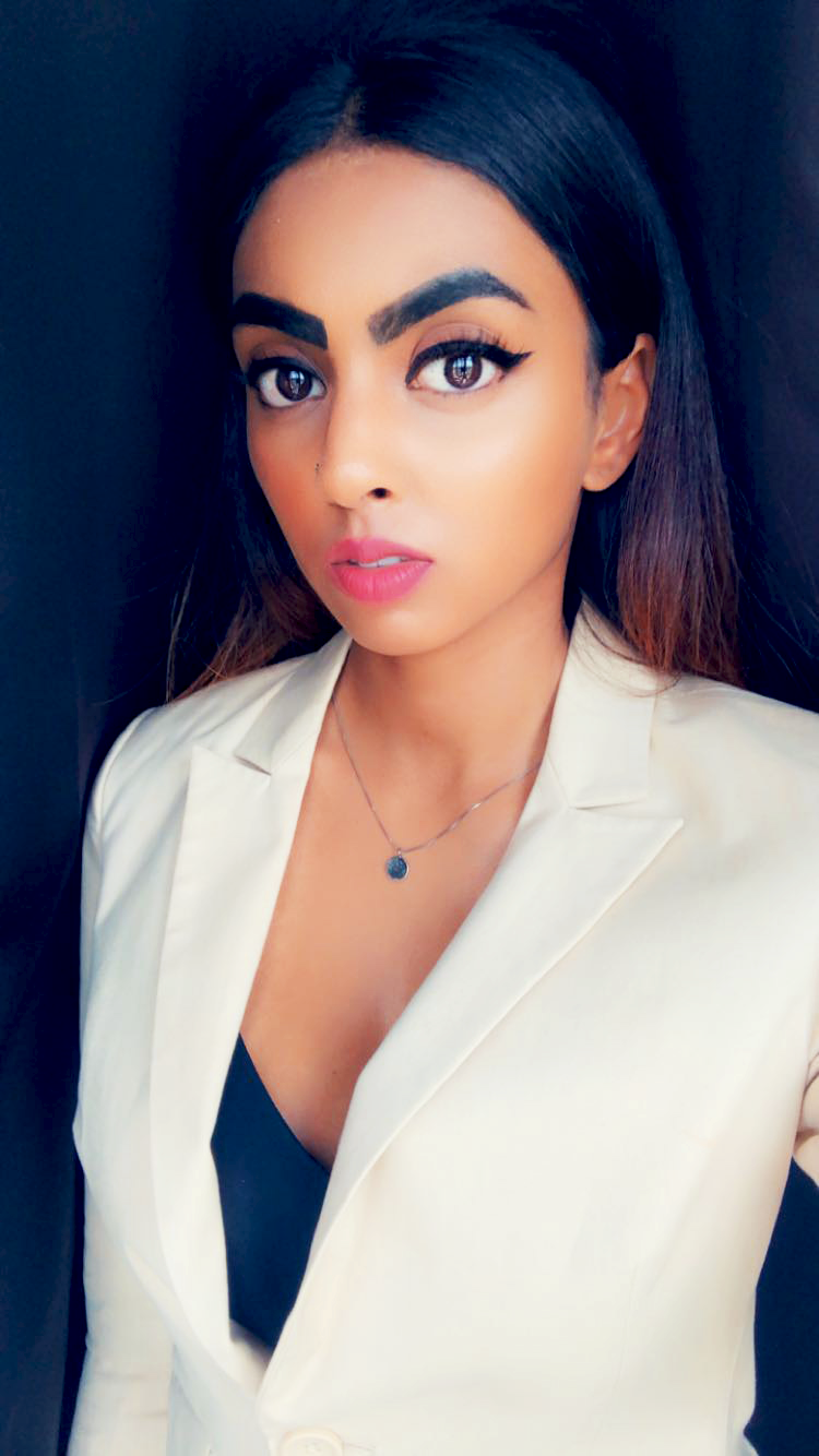 Picture of Rebecca, wearing a white blouse and black top