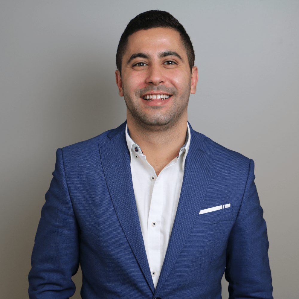 Picture of Adam wearing a blue blazer and a white shirt