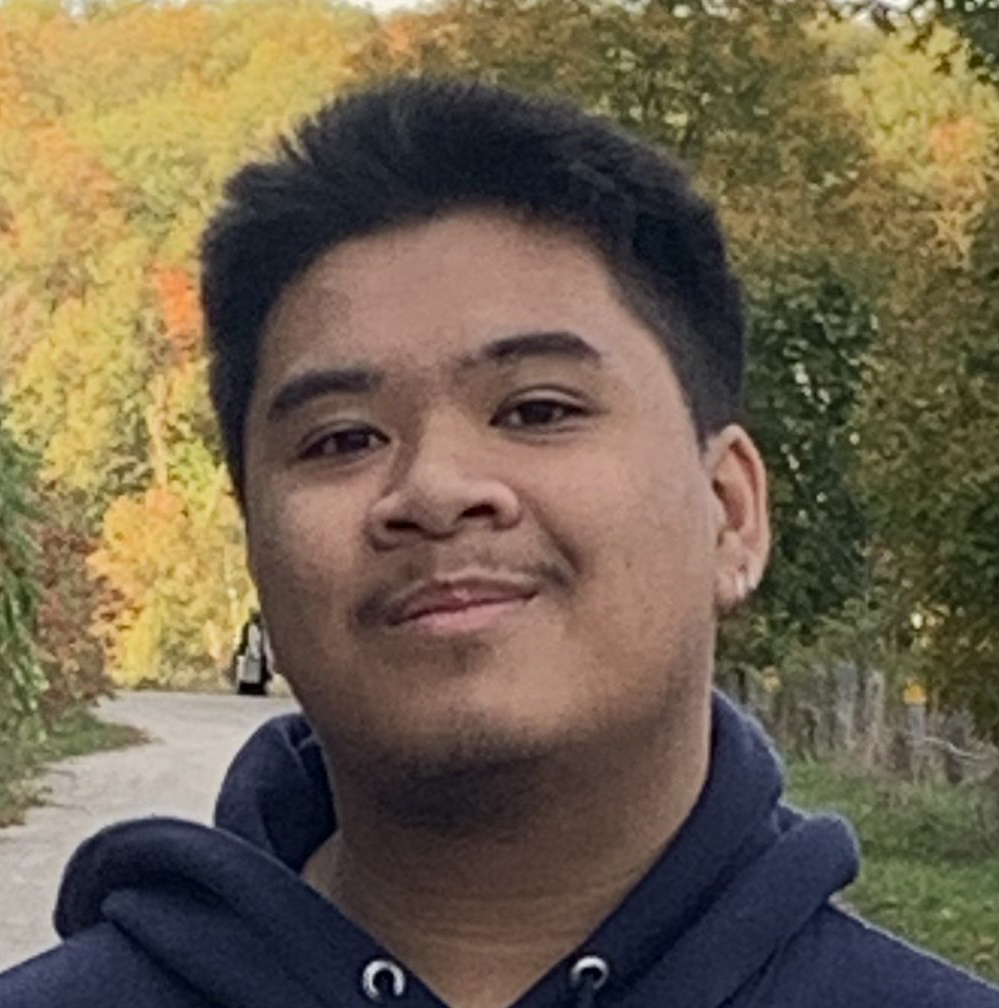 Picture of Hernan, outdoors wearing a blue hoodie