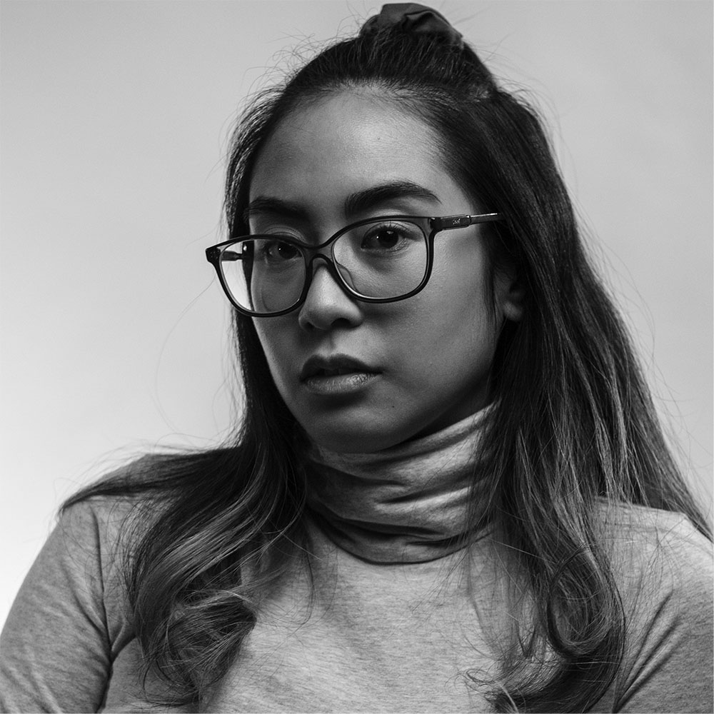 Black and white picture of Leah wearing a turtle neck swwater
