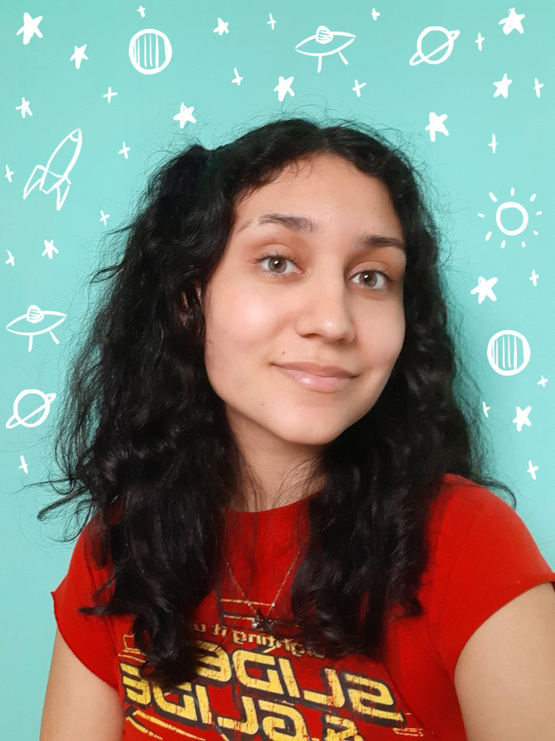 Isabel, a tanned woman with long curly dark brown hair, is standing in front of a teal wall. She is wearing a red shirt with yellow font on it and is smiling at the camera. The background has drawn in doodles of space ships and planets and stars.
