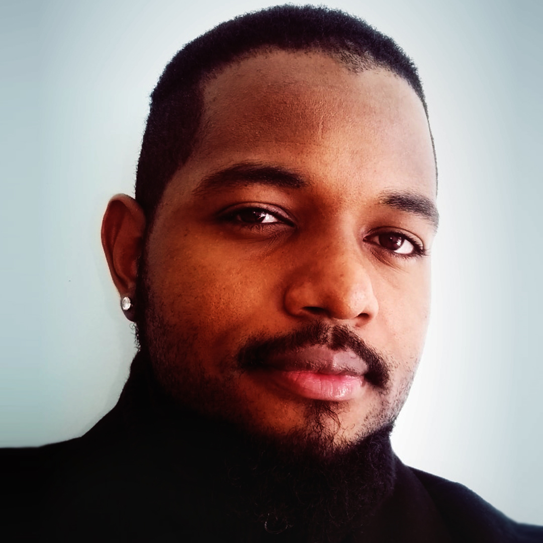 A picture of Tevin inside smiling at the camera.