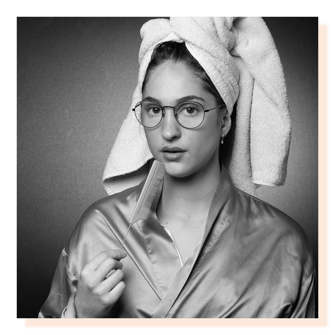 Girl with hair in a bath towel looking at the camera