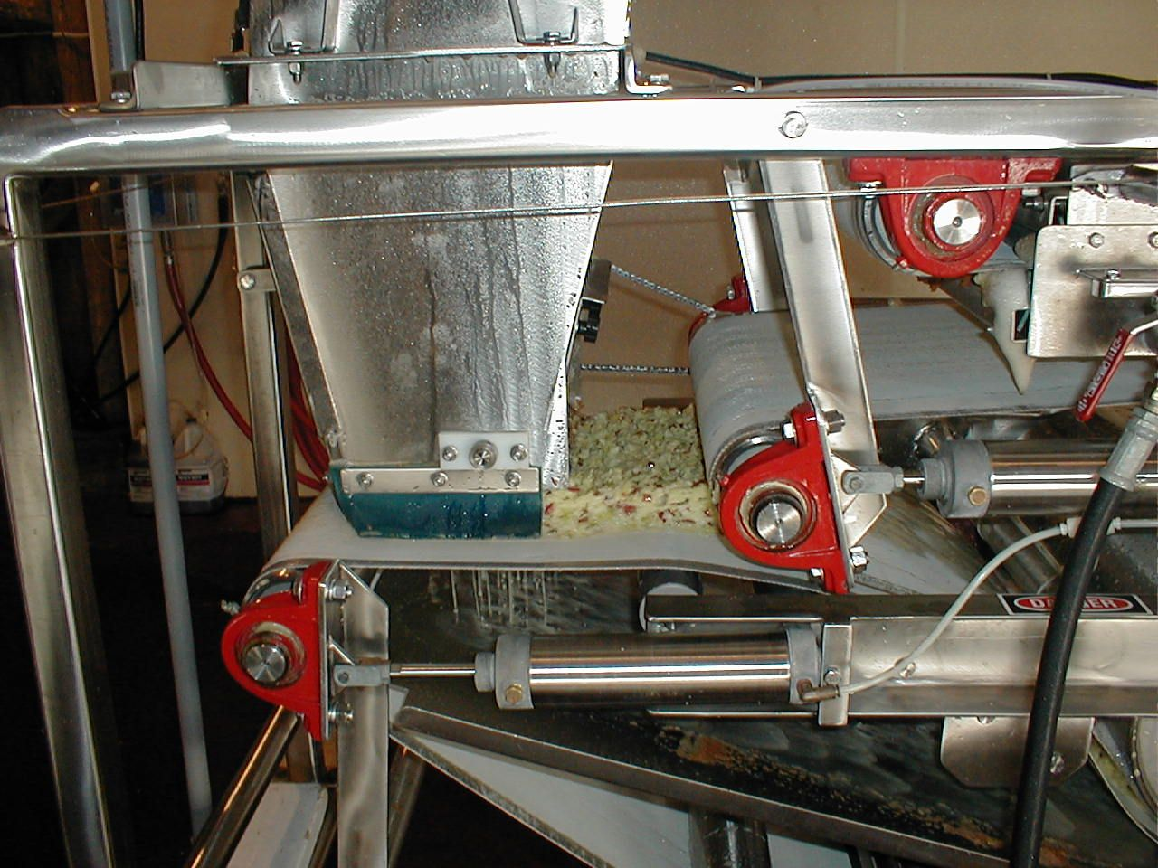 3. Once the apples are chopped, they are squeezed by a series of belts which apply constant pressure to the chopped apples. We now have cider!