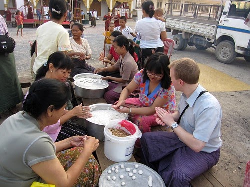 People eating Mone Lone Yay Paw on the street in Myanmar