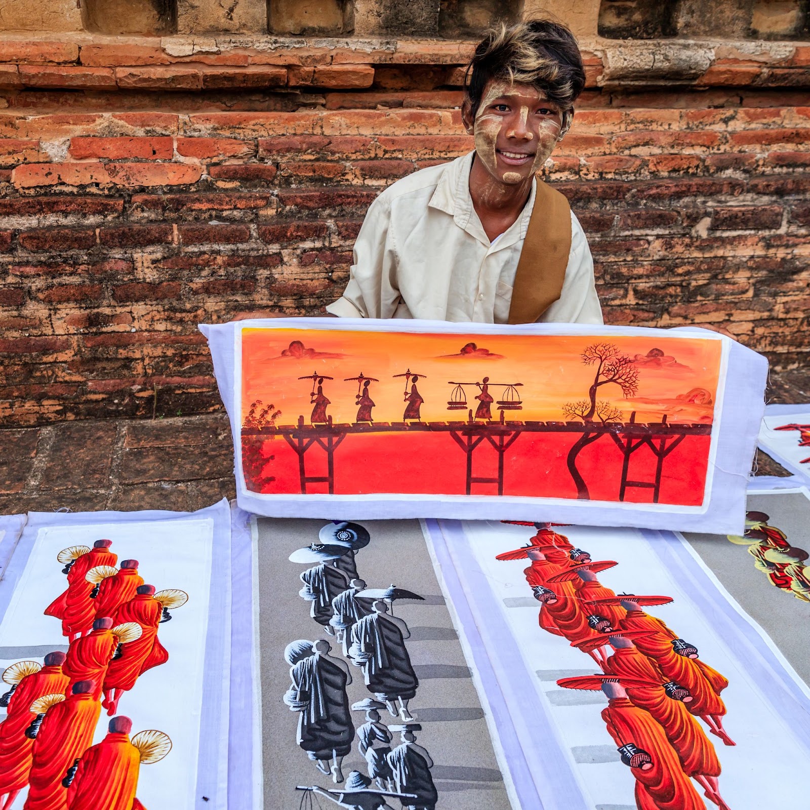 Shop owner displaying his hand-painting