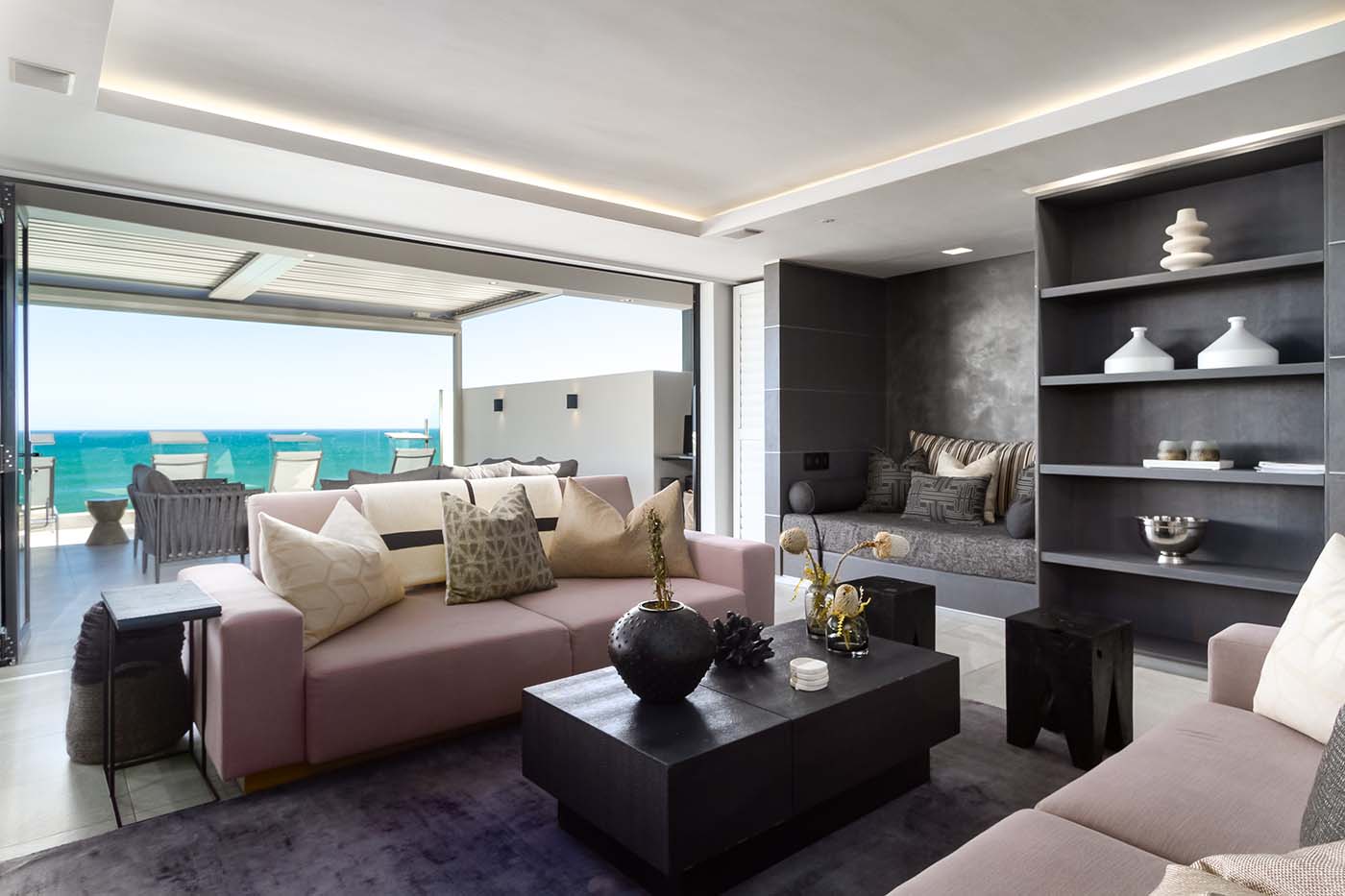 The home provides different vignettes for living, with each new setting primed for making memories. Here the neutral coloured casual lounge with ocean views.