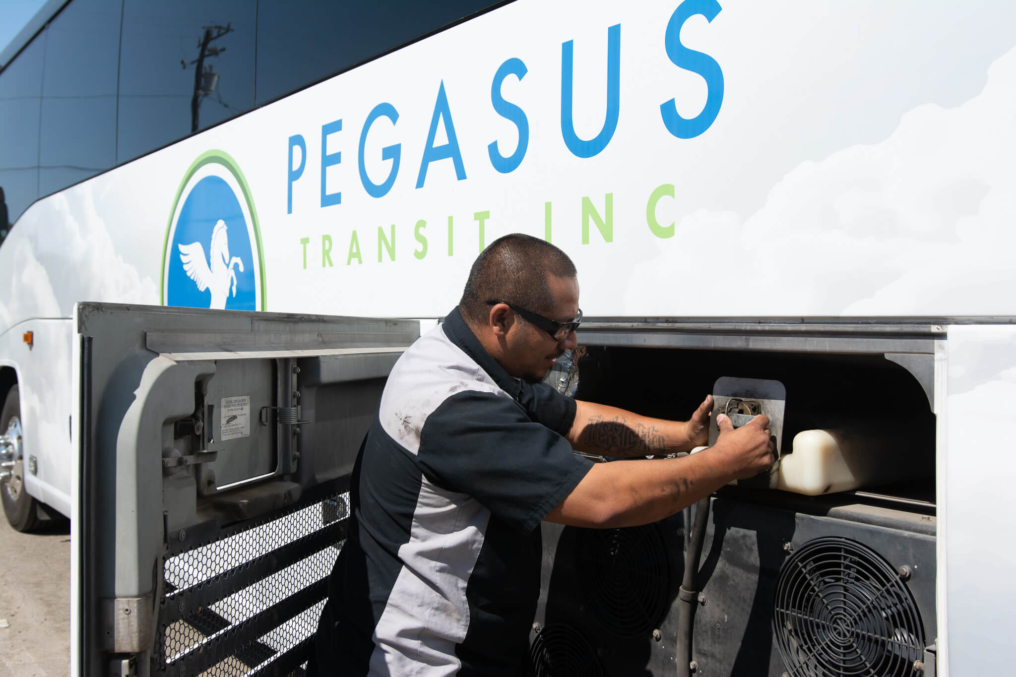 Pegasus Transit mechanic working on coach bus.