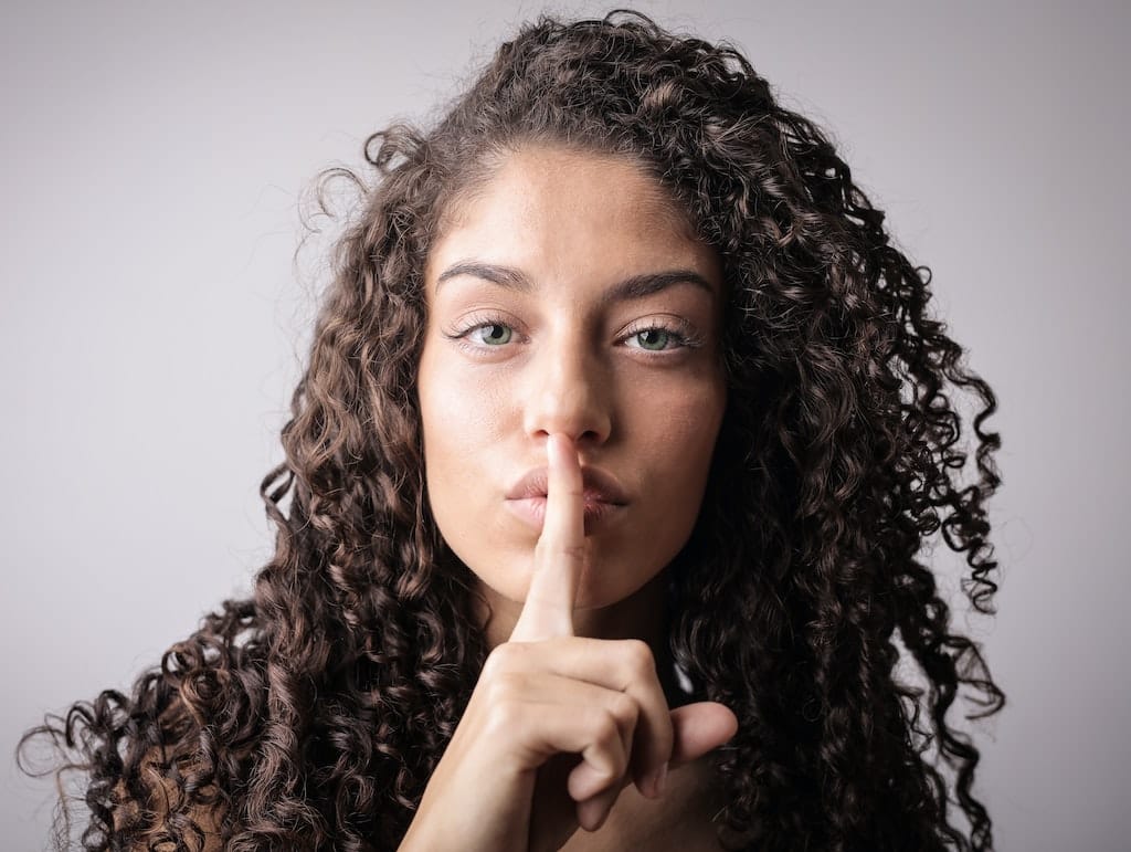 girl-making-hush-gesture