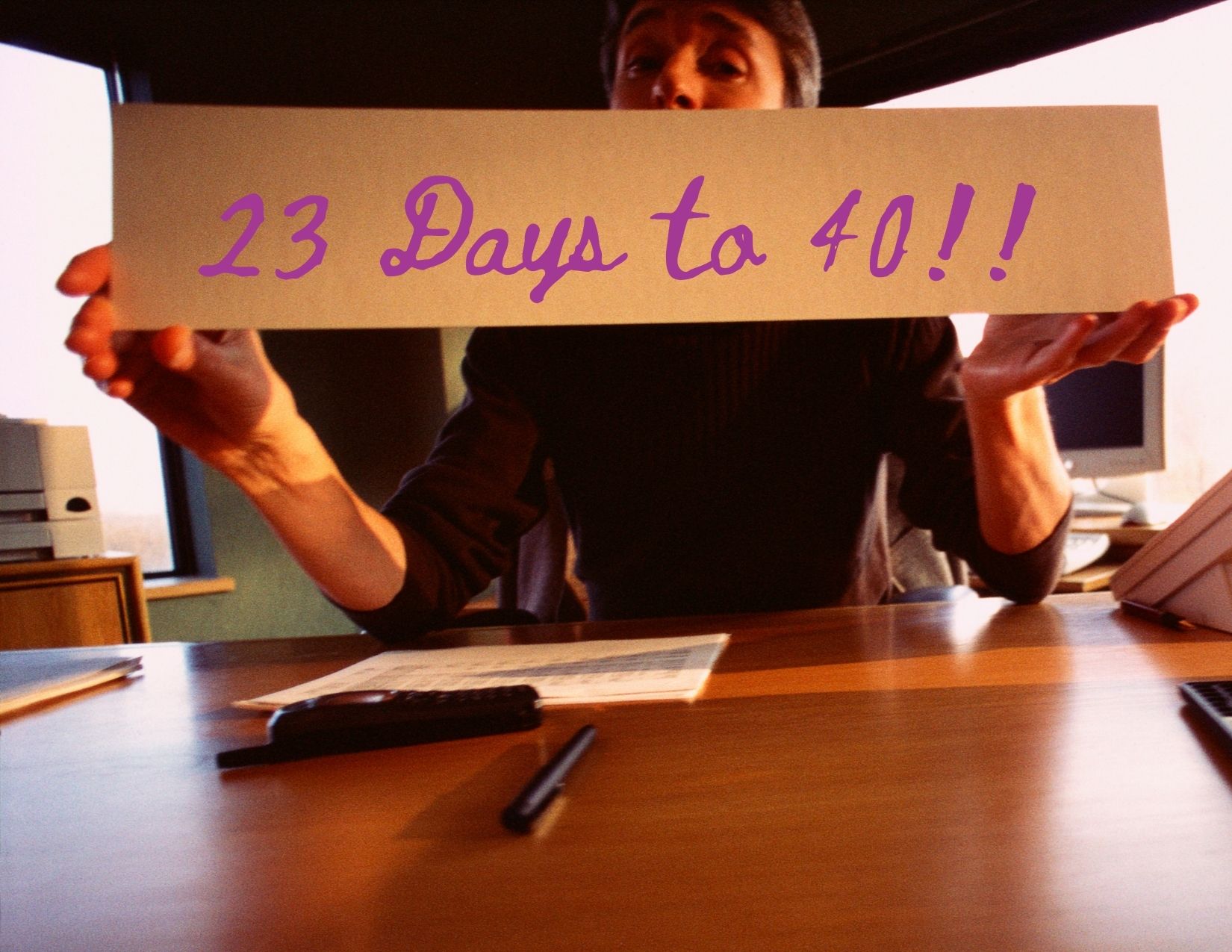 person holding sign that says 23 days to 40