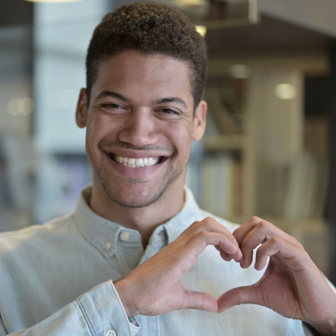 young man making heart with hands