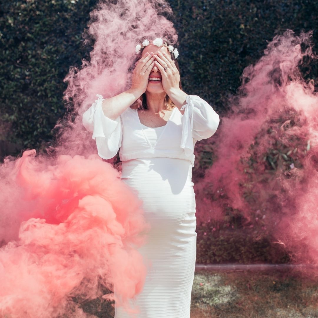 pregnant woman surrounded by pink