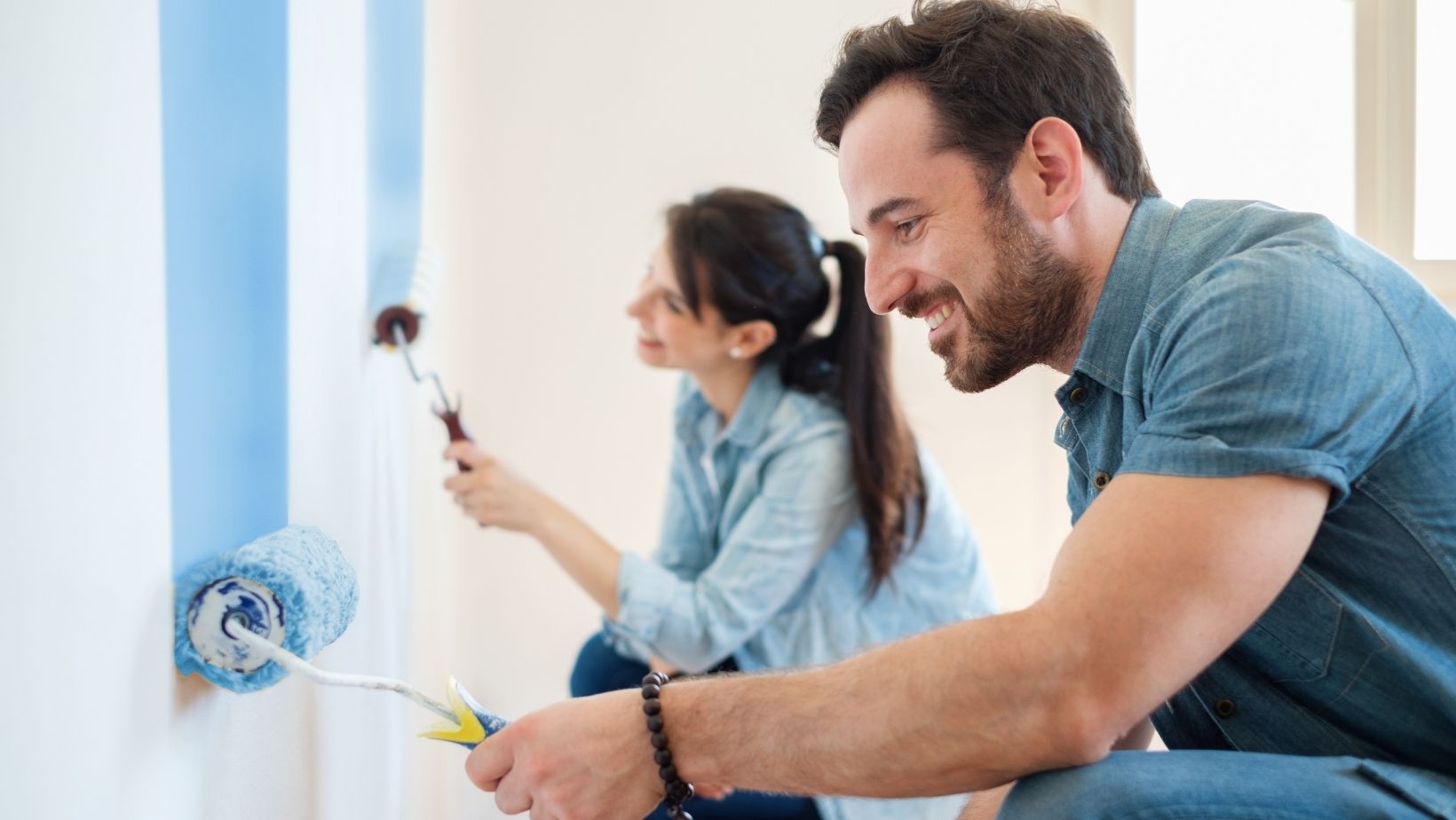 couple painting a wall