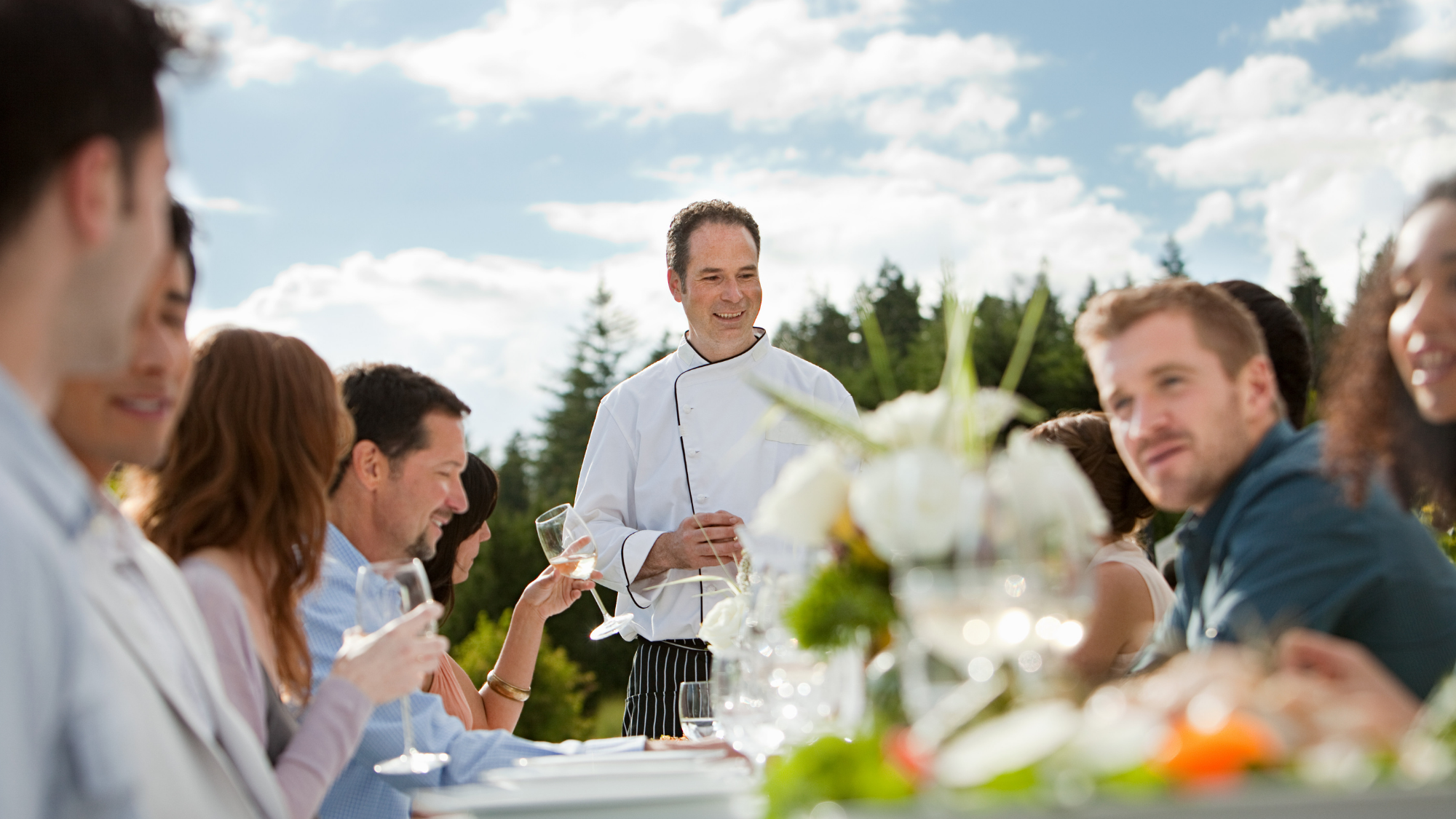 outdoor dinner party with chef