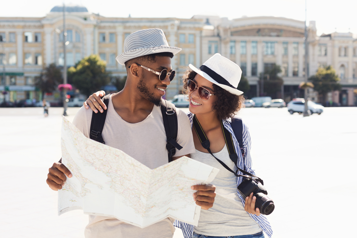 couple on vacation with map