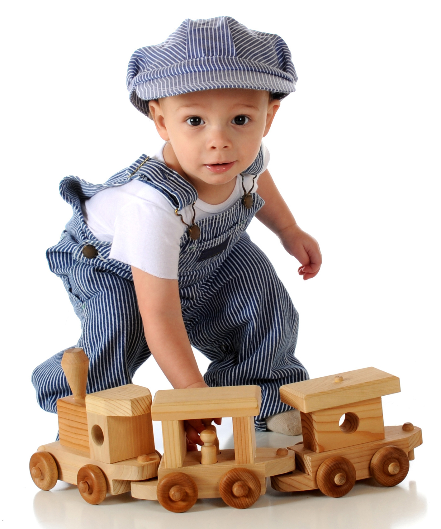 young boy playing with wooden train