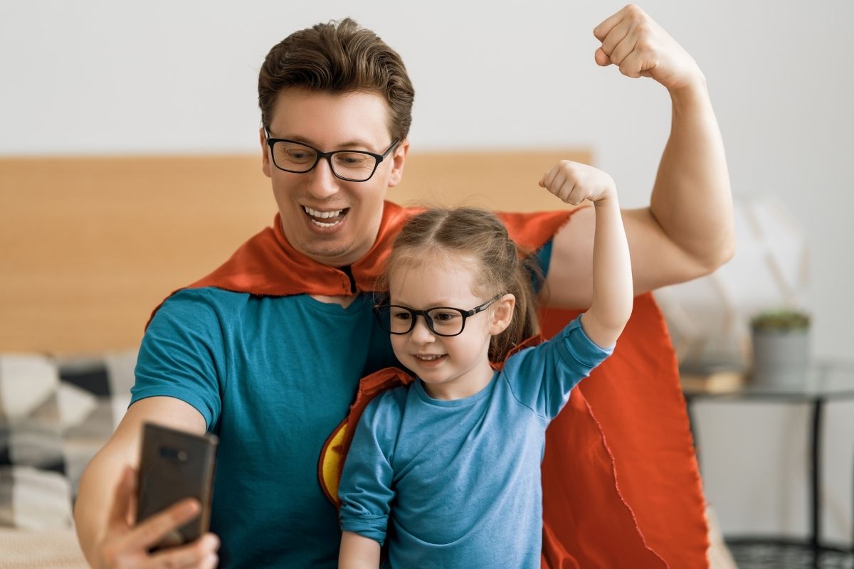 father and daughter in superhero costumes