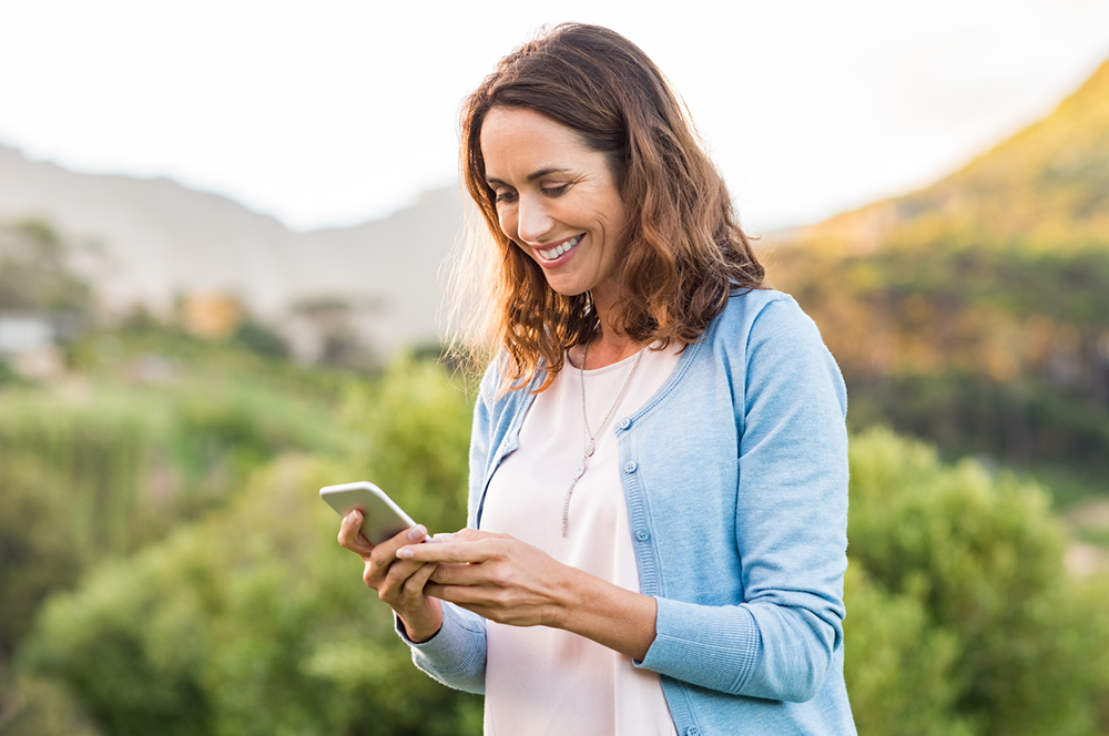woman smiling at phone