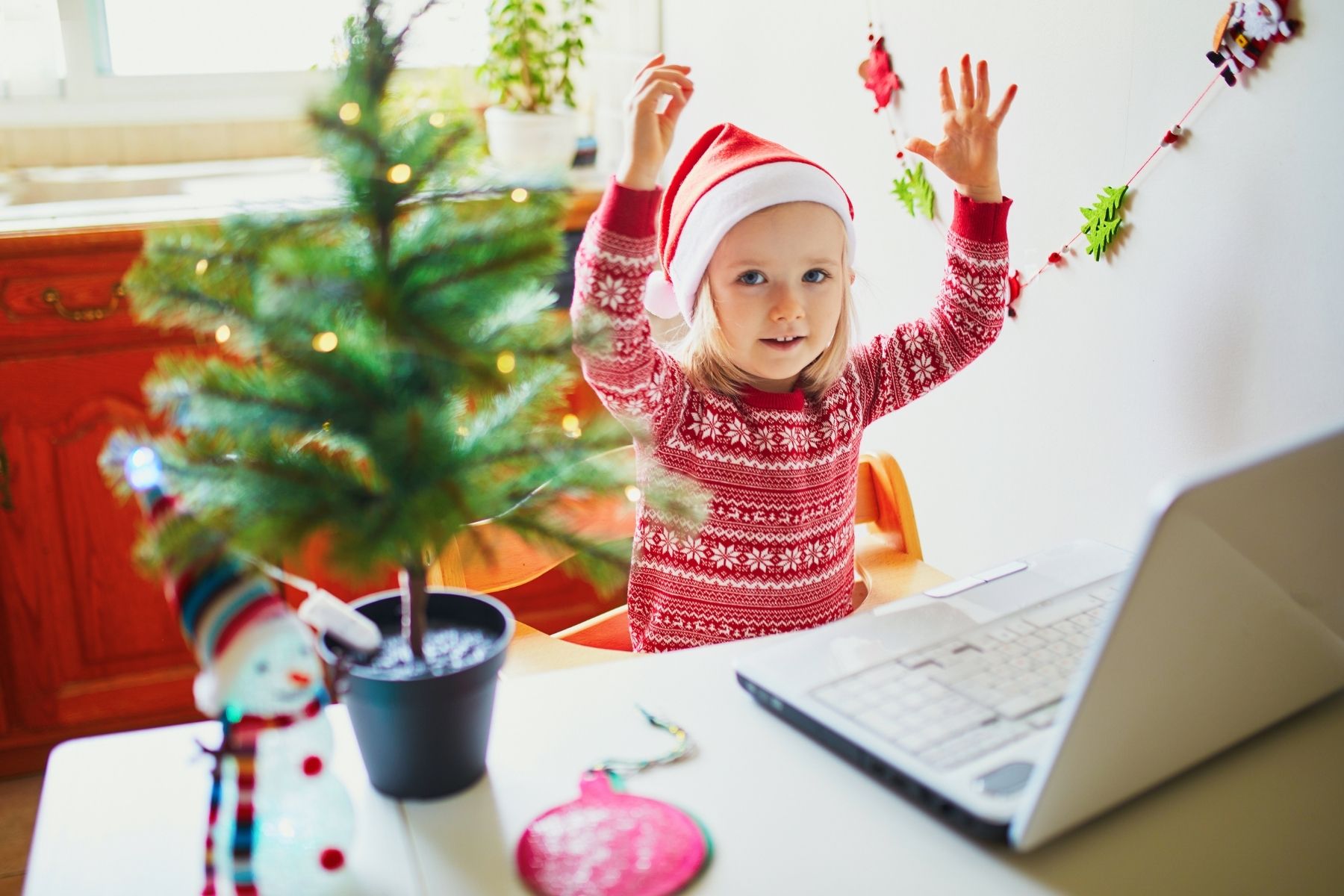 a little girl singing christmas carols into computer