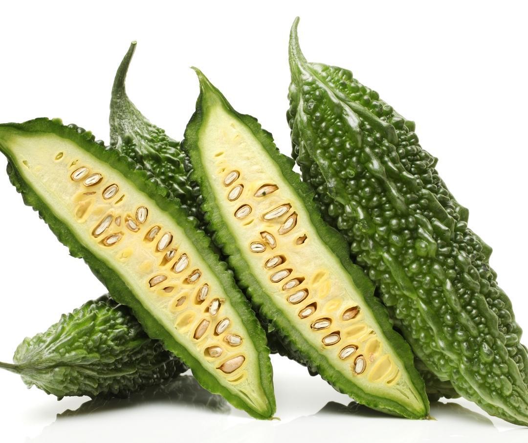 an image of bitter melon, halved; on a white background.