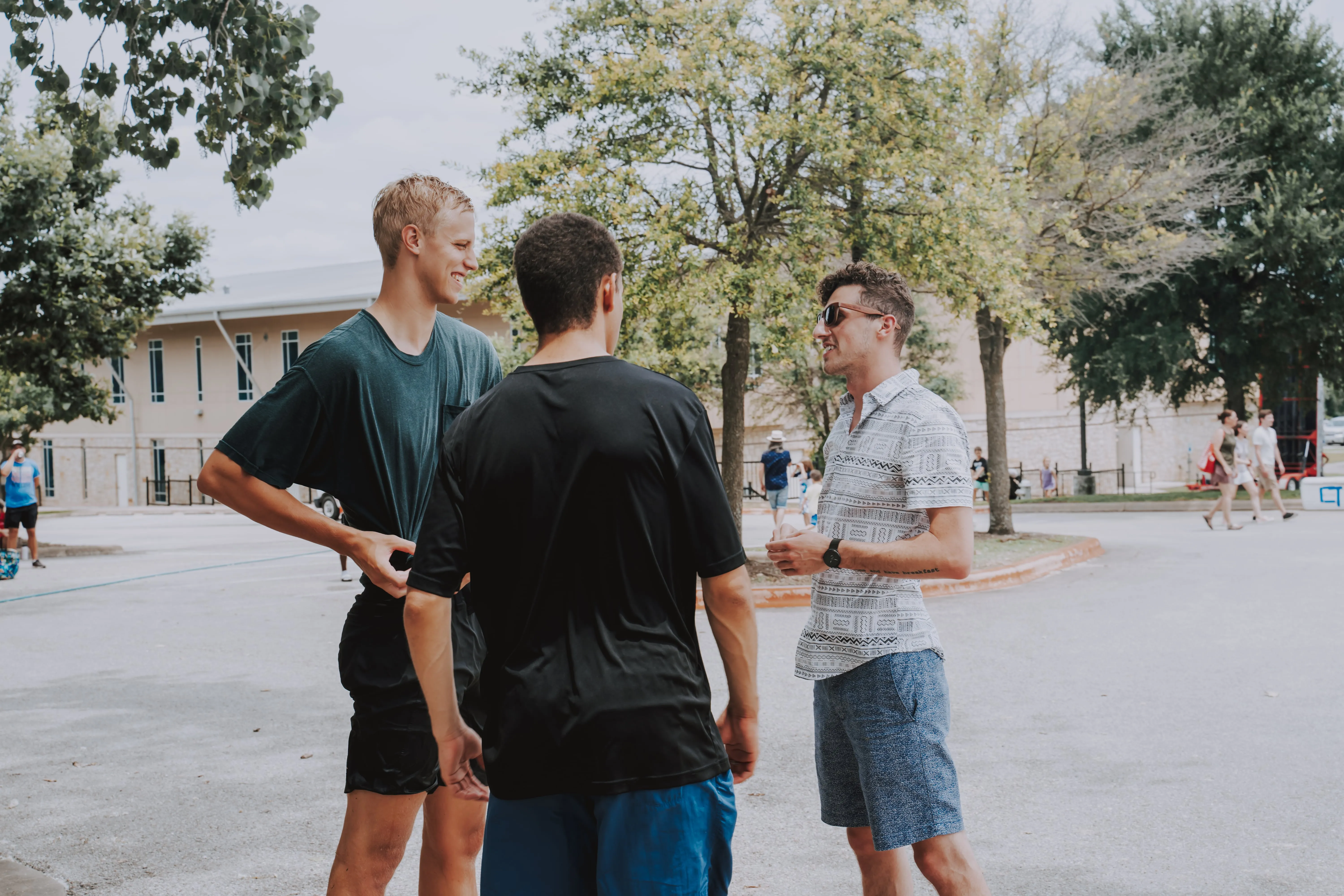 a group of men talking outside