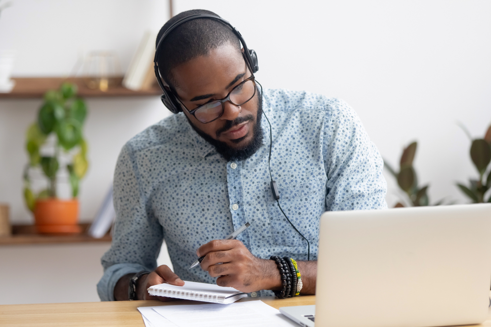 Person learning on laptop about common customer relationship challenges in the insurance industry