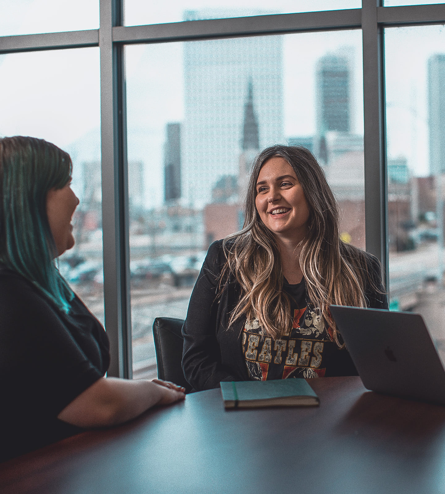 Leadline team members at a meeting table discussing project and being positive