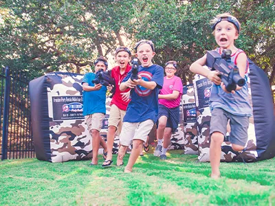 outdoor laser tag boys running towards camera