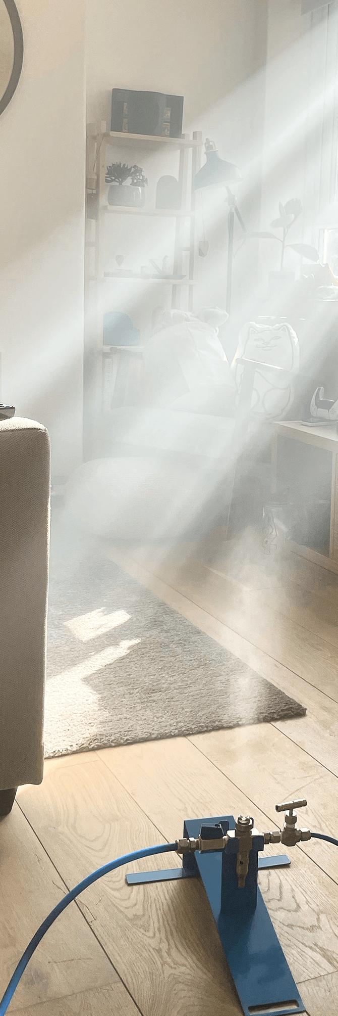 One third of an image split up for effect, that shows our dry fog sterilant filling a living room in order to resolve the mould problem