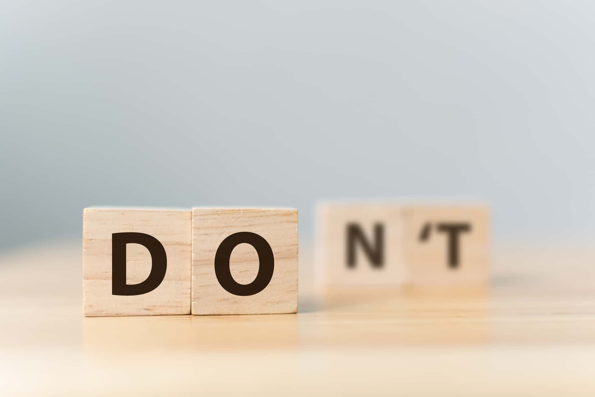 Wood Blocks of Do in the foreground with NT faded in the background