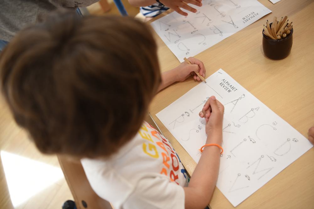 Child learns english alphabet in a bilingual preschool