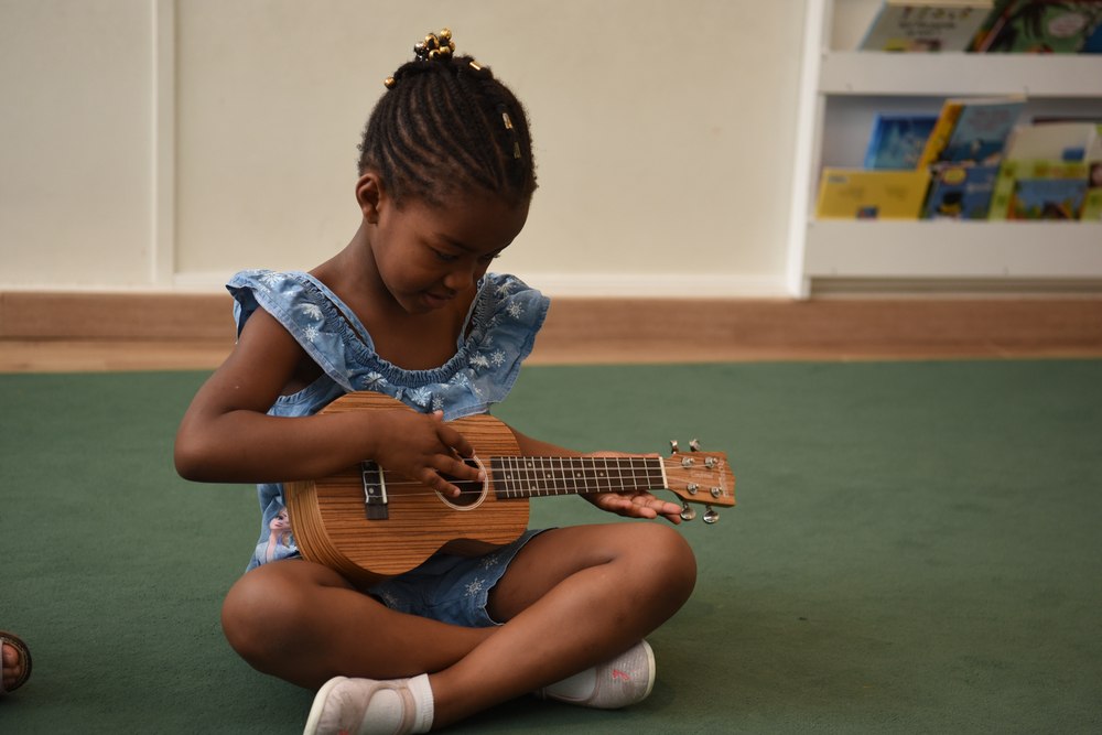 Child learning music with a guitar