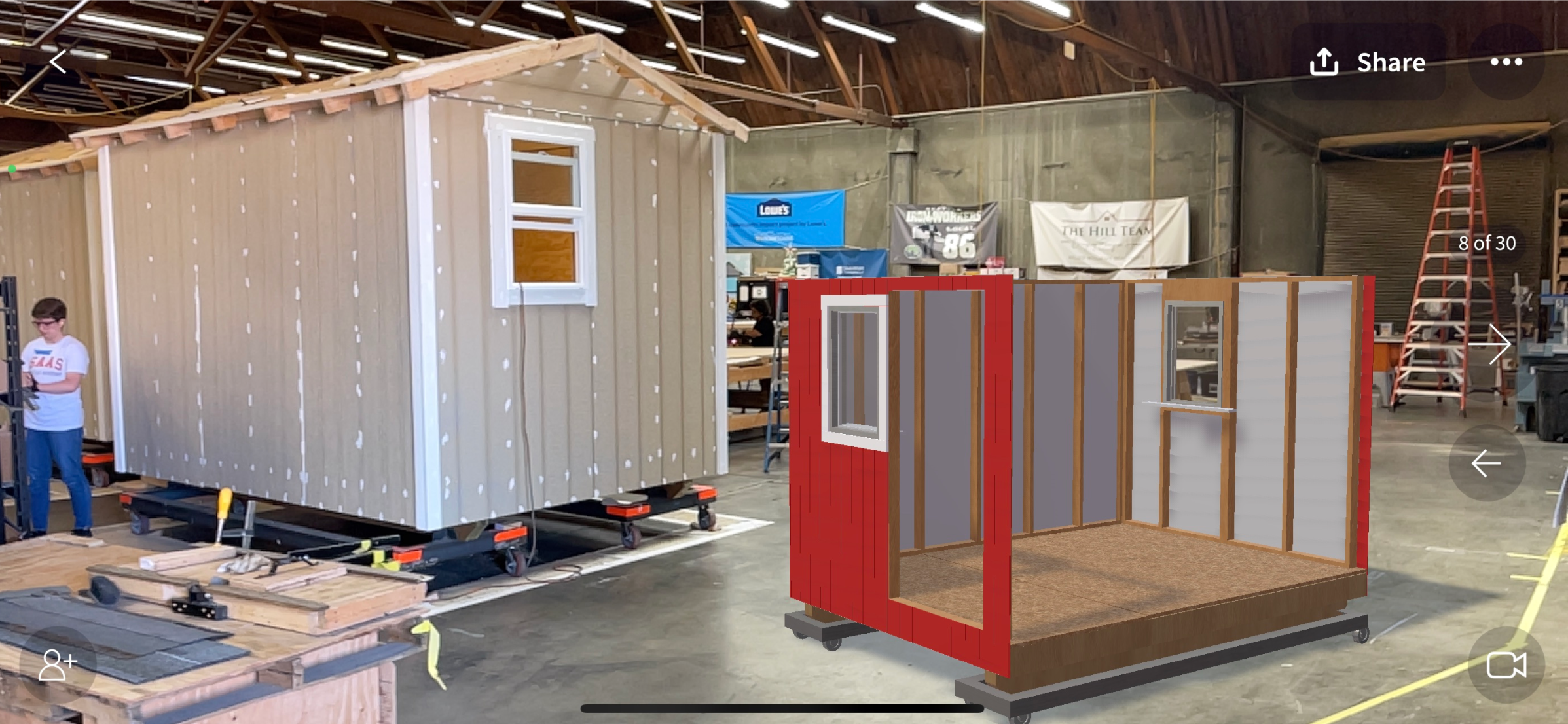 3D model of a tiny home product being viewed in augmented reality next to a real tiny home product using JigSpace